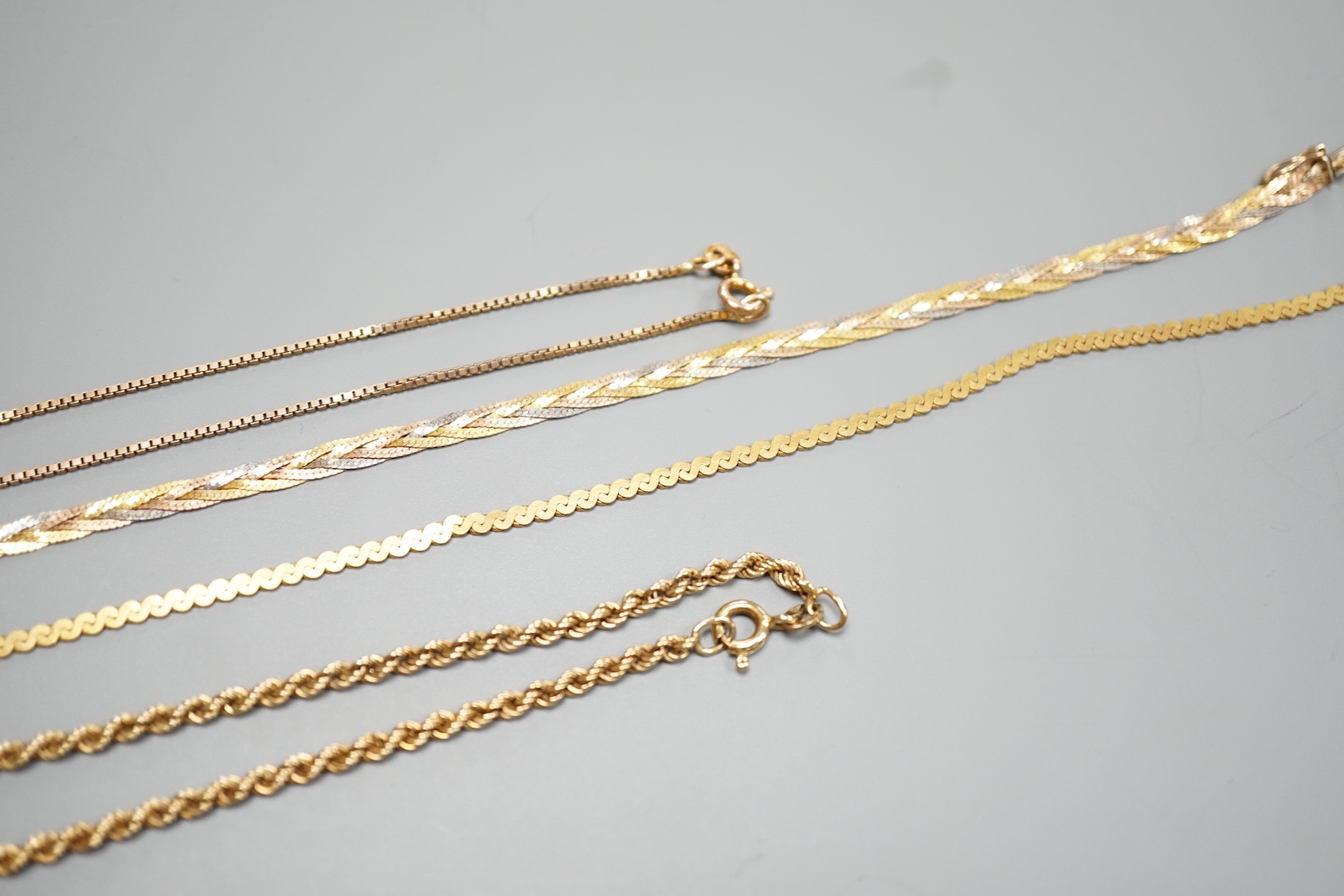 Four assorted modern 9ct chains, including three colour and rope twist, largest 38cm, 25.1 grams.